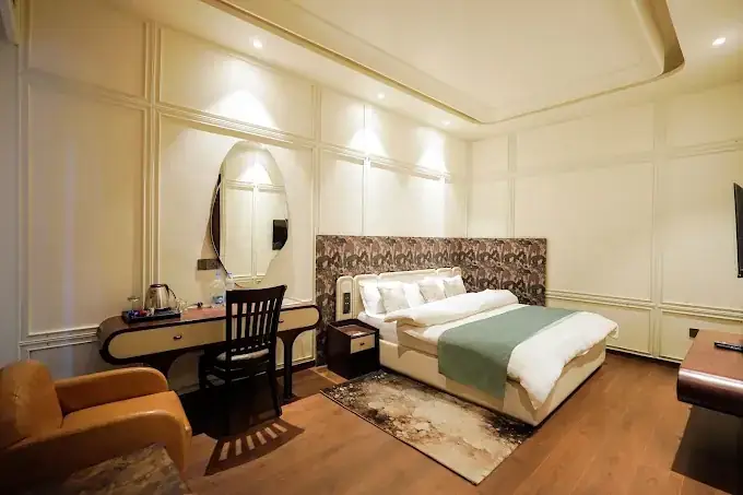 Premium room with king bed, printed headboard and writing desk