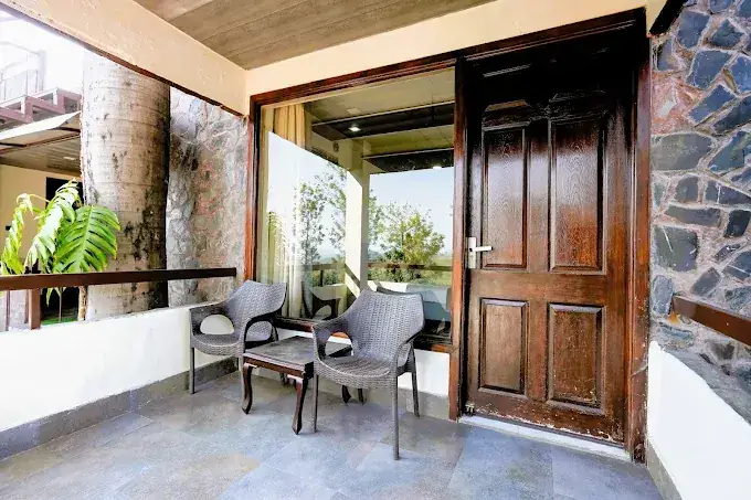 Private room balcony with cane seating and valley views