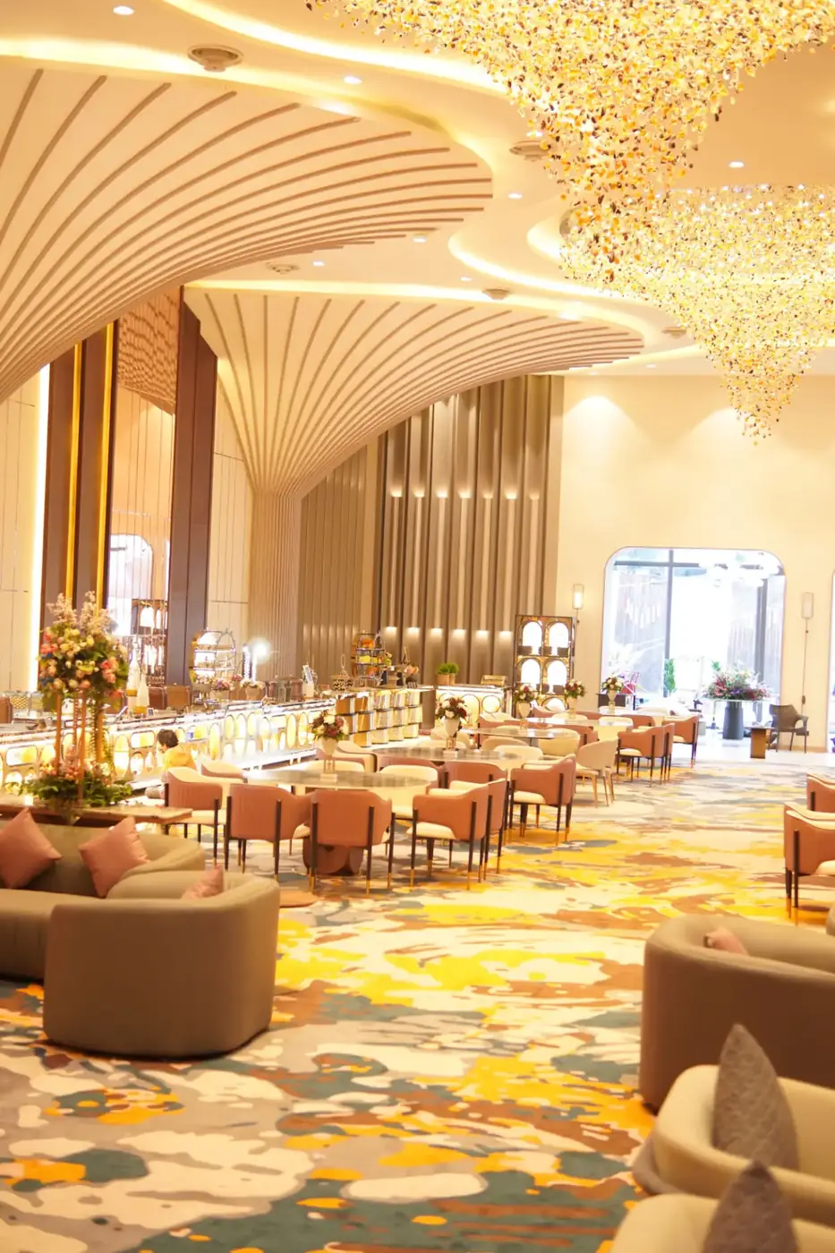 Grand multi-cuisine restaurant with sculpted ceiling and chandeliers