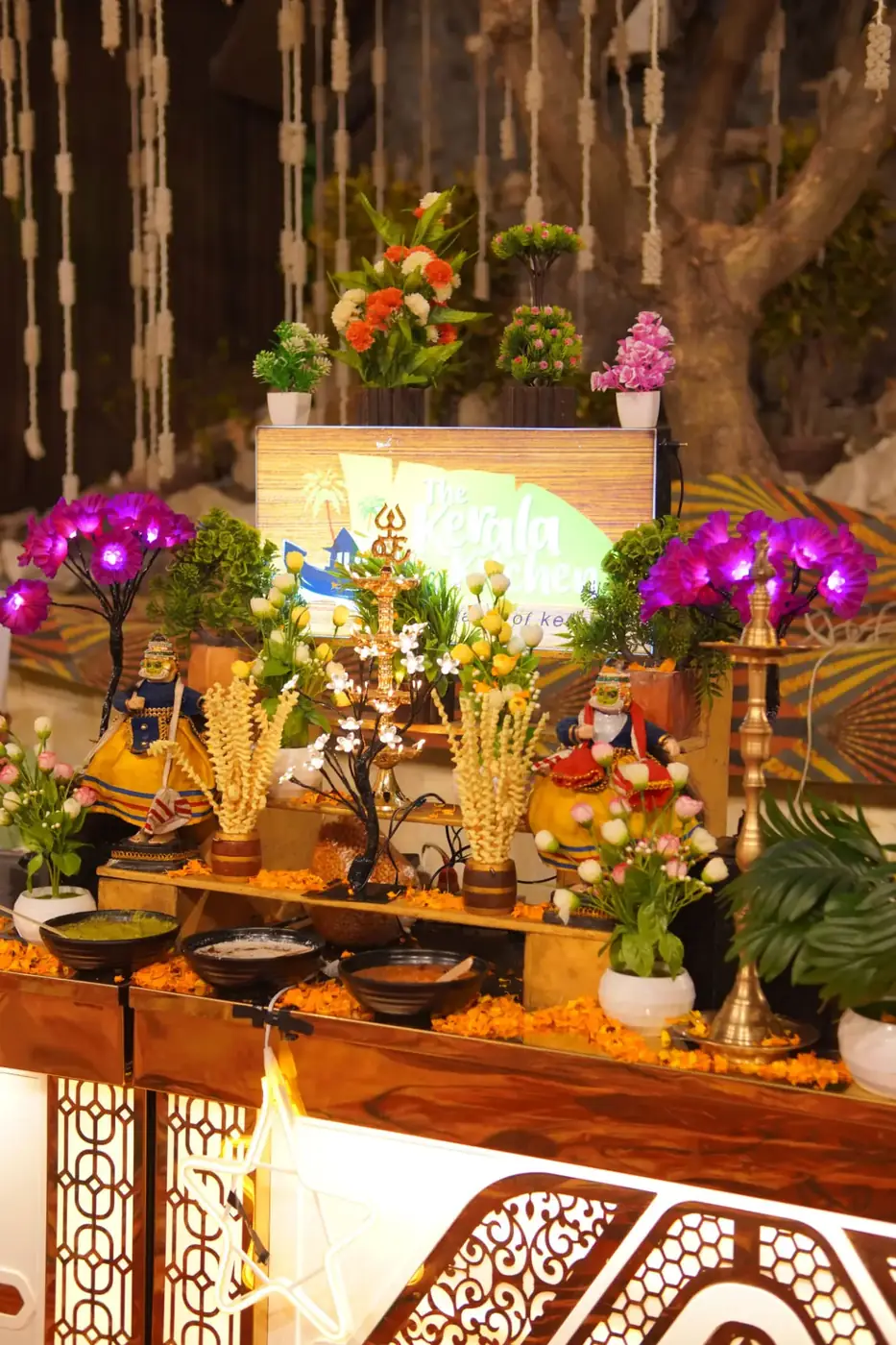 Kerala Kitchen themed live counter with brass lamps and florals