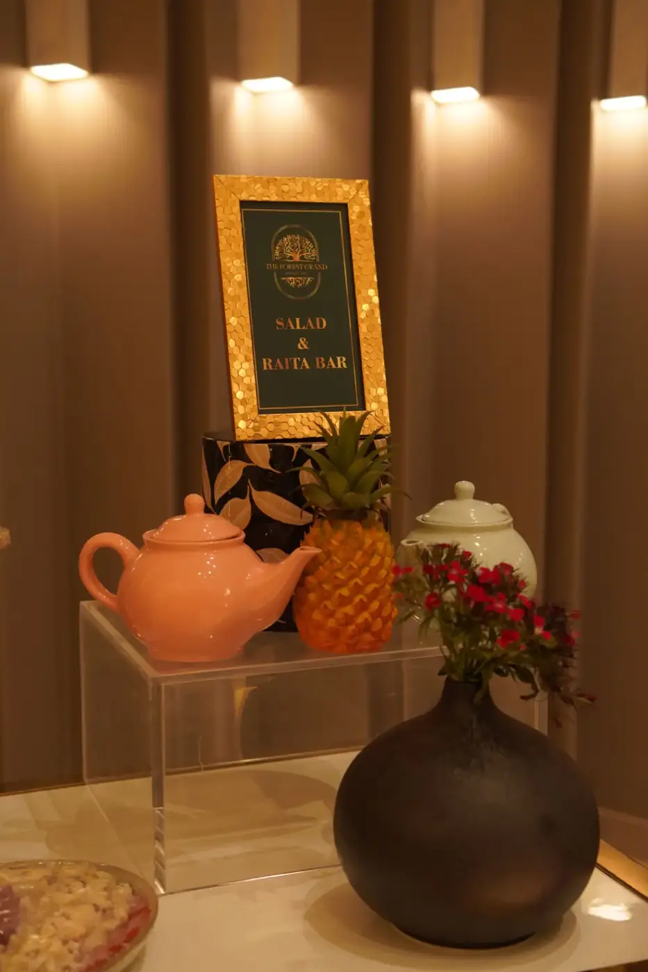 Salad and raita bar styled with brass frames and ceramics