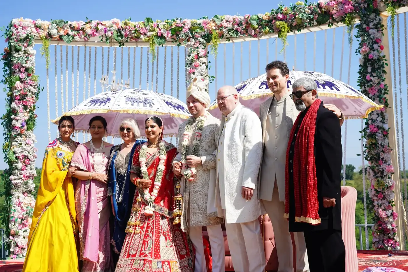 Couple and family under the floral mandap after the wedding ceremony